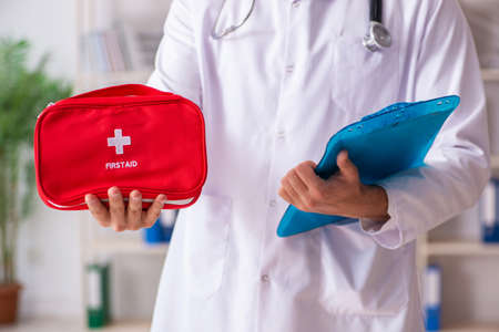 Male doctor with first aid bagの写真素材