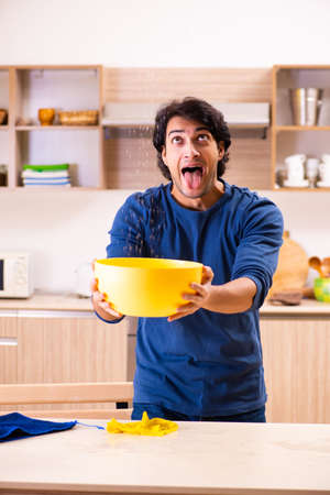 Young man in water leakage from the neighbors conceptの写真素材