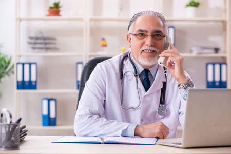 Aged male doctor working in the clinicの写真素材