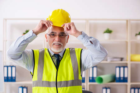 Aged construction engineer working in the officeの写真素材