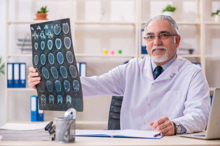 Aged male doctor radiologist in the clinicの写真素材