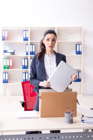 Young female employee being fired from her workの写真素材
