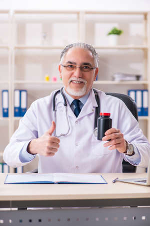 Aged male doctor working in the clinicの写真素材