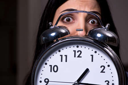 Young female student preparing for exams at night time