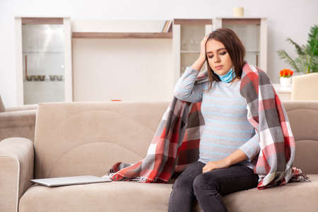 Sick pregnant woman suffering at homeの写真素材