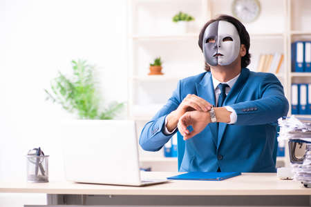 Male employee in the office in industrial espionage conceptの写真素材