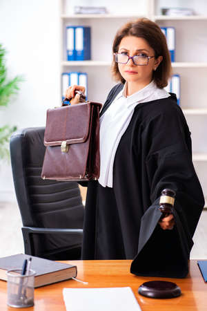 Middle-aged female doctor working in courthouseの写真素材