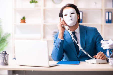 Male employee in the office in industrial espionage conceptの写真素材