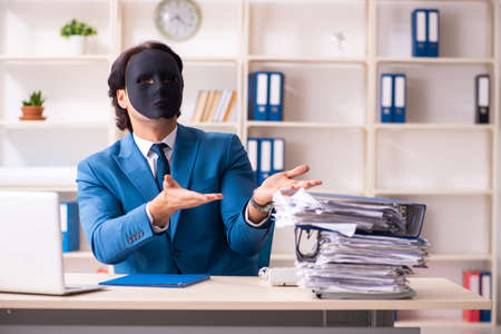 Male employee in the office in industrial espionage conceptの写真素材