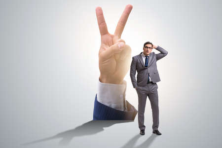 Businessman showing victory gesture in business conceptの写真素材