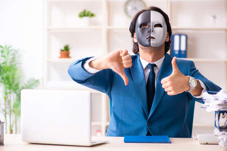 Male employee in the office in industrial espionage conceptの写真素材