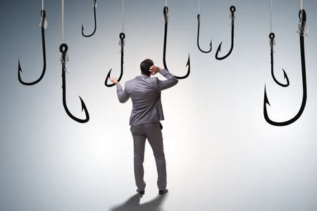 Businessman being tempted to bite the baitの写真素材