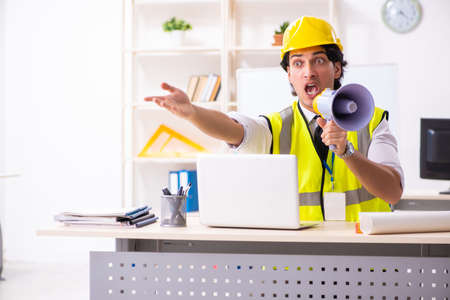 Male construction engineer working in the officeの写真素材