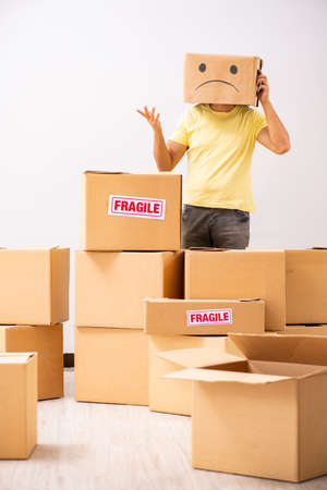 Unhappy man with box instead of his headの写真素材