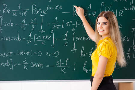 Young female student in front of the chalkboard