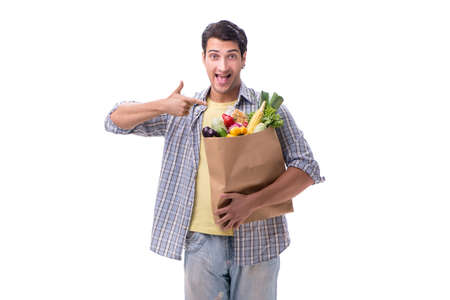 Young man with his grocery shopping on whiteの写真素材