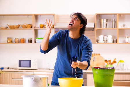 Young man in water leakage from the neighbors conceptの写真素材