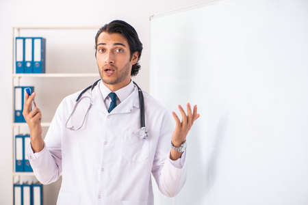 Young doctor in front of whiteboardの写真素材
