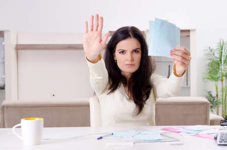 Young woman with receipts in budget planning concept