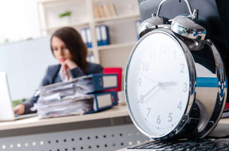 Beautiful female employee unhappy with excessive workの写真素材