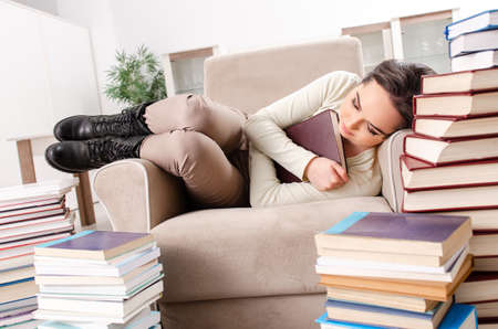 Young female student preparing for exams at home
