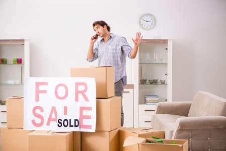 Young man offering home for sale and moving outの写真素材