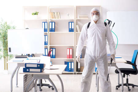 Professional contractor doing pest control at officeの写真素材