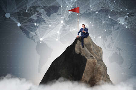 Businessman at the top of mountainの写真素材