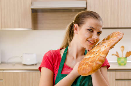 Young female baker working in kitchen