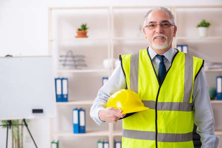 Aged construction engineer working in the officeの写真素材