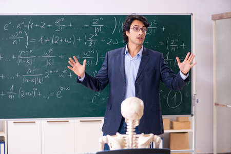 Young male math teacher and student skeletonの写真素材