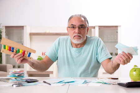 White bearded old man in budget planning concept