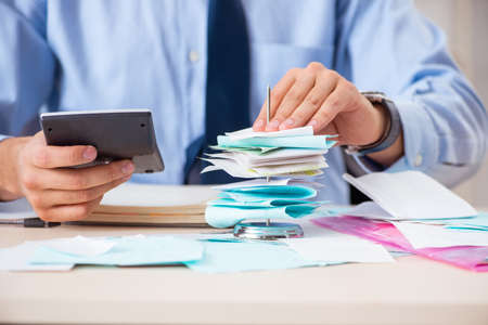 Young handsome businessman in budget planning concept