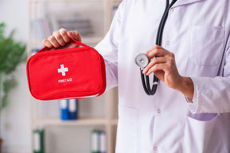 Male doctor with first aid bagの写真素材