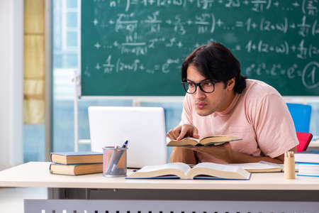 Young male student in the classroomの写真素材
