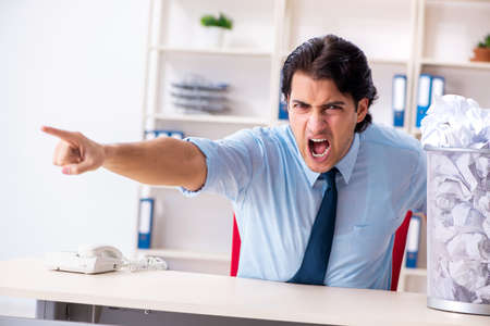 Businessman rejecting new ideas with lots of papersの写真素材