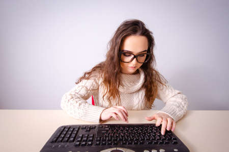 Funny nerd girl working on computerの写真素材