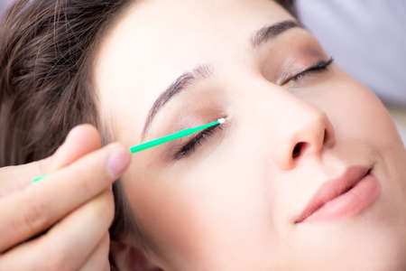 Young woman visiting male doctor cosmetologist
