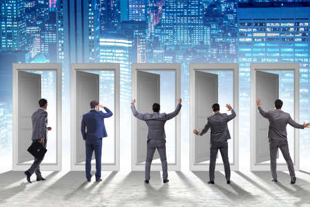 Businessman in uncertainty concept with many doorsの写真素材