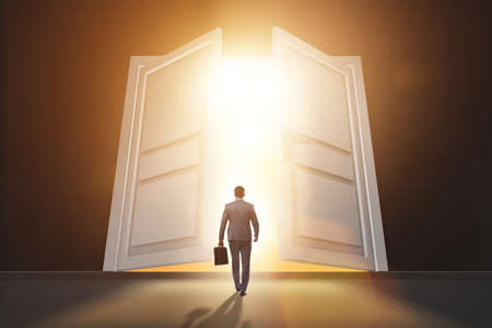 Businessman entering big large doorの写真素材