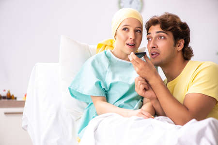 Husband looking after wife in hospitalの写真素材