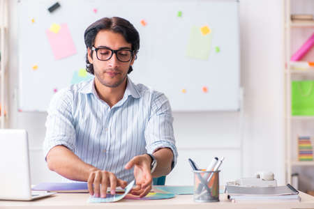 Young handsome male designer working in the officeの写真素材