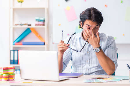 Young handsome male designer working in the officeの写真素材