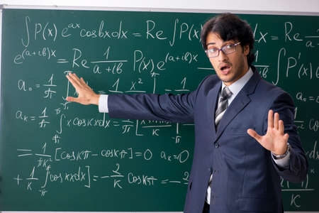 Young male math teacher in classroom