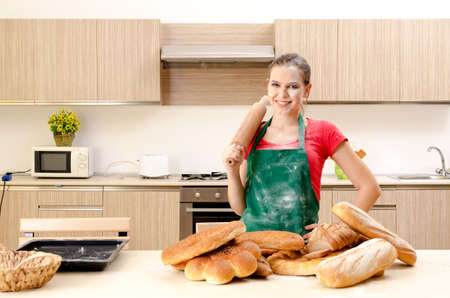 Young female baker working in kitchen