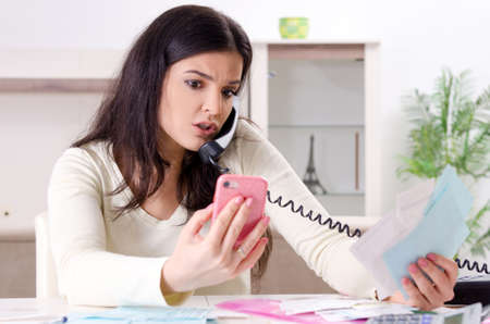 Young woman with receipts in budget planning conceptの写真素材