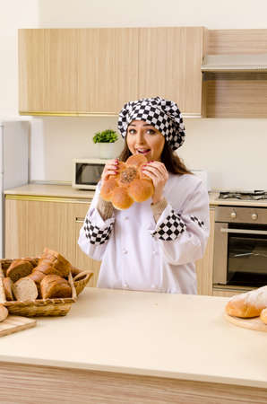 Young female baker working in kitchen