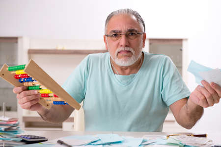 White bearded old man in budget planning concept