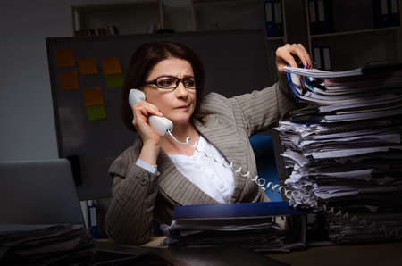 Female employee suffering from excessive workの写真素材