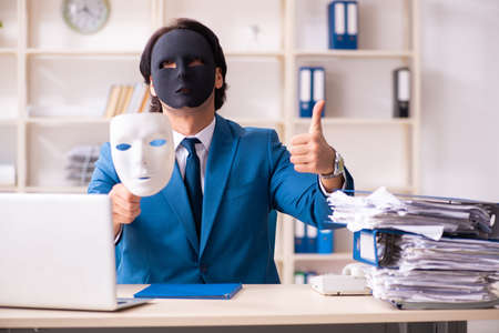 Male employee in the office in industrial espionage conceptの写真素材